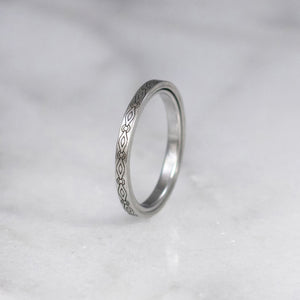Engraved sculpted steel gamos interlocking engagement and wedding ring